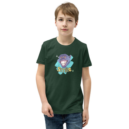  A boy standing wearing a forest green kids t-shirt with the printed graphic of a smiling monkey and the word, Smile. Designed by Wizard Prints