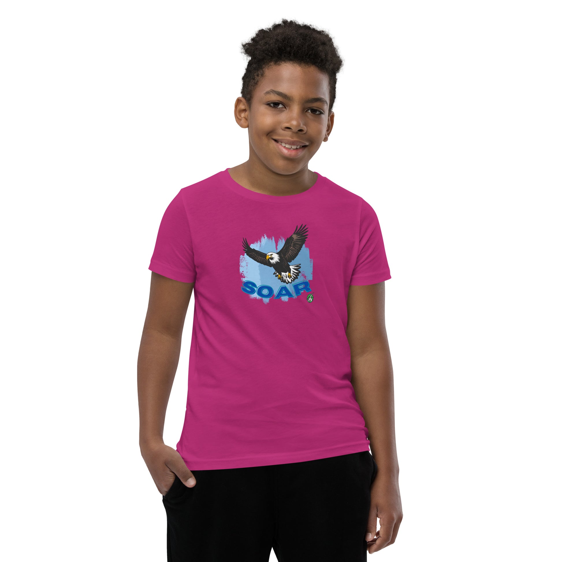 A boy wearing a Wizard Prints kids t-shirt in berry colour with a printed graphic on the front of an eagle soaring in the sky.