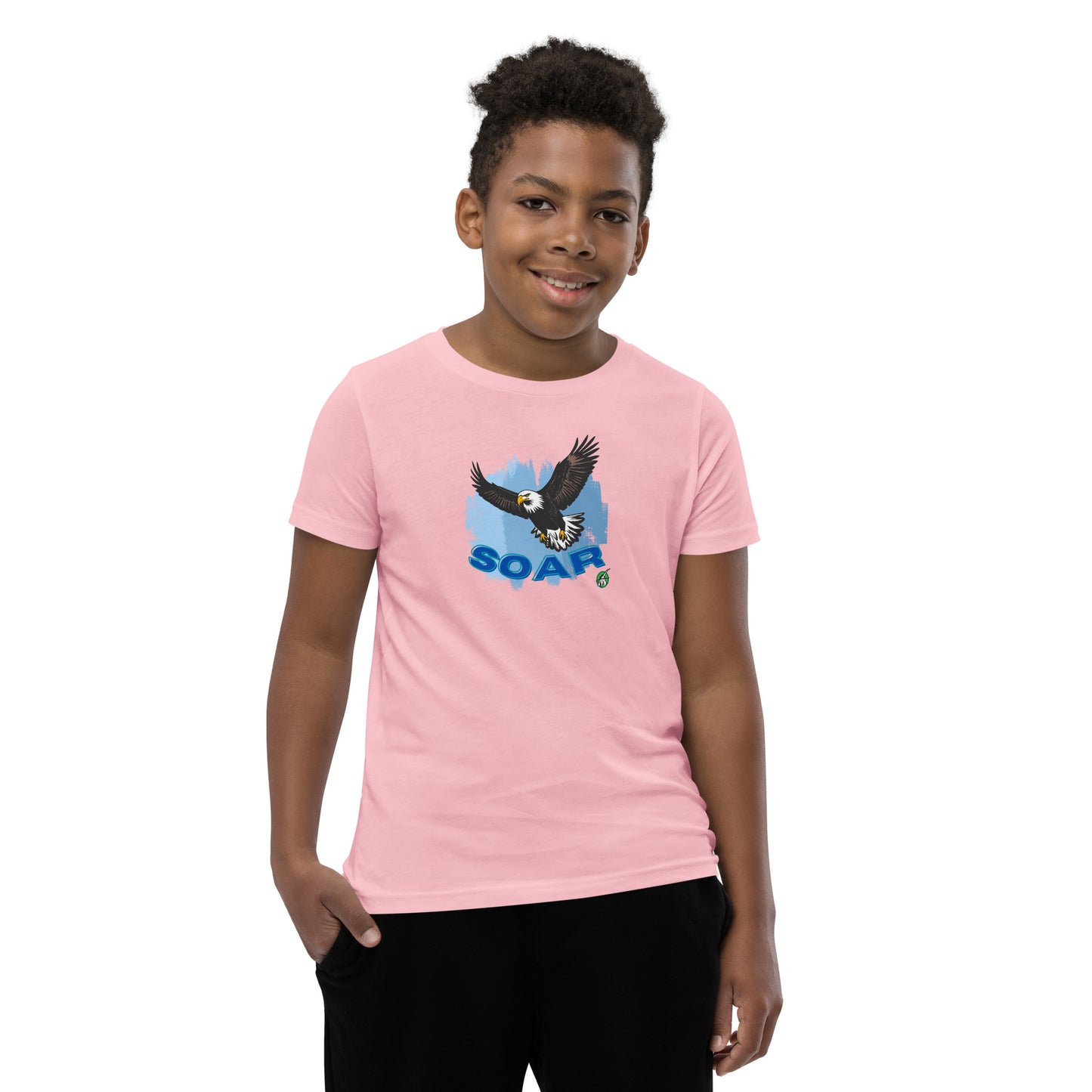 A boy wearing a Wizard Prints kids t-shirt in pink with a printed graphic on the front of an eagle soaring in the sky.