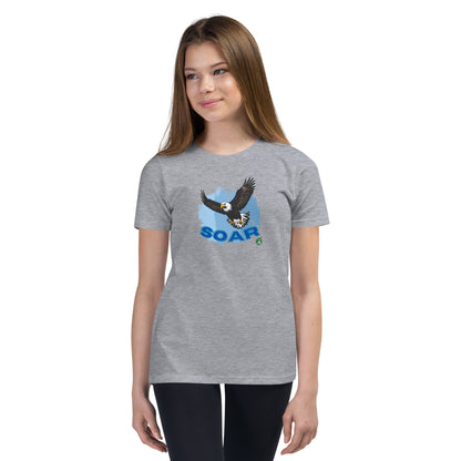 A girl wearing a Wizard Prints kids t-shirt in grey with a printed graphic on the front of an eagle soaring in the sky.