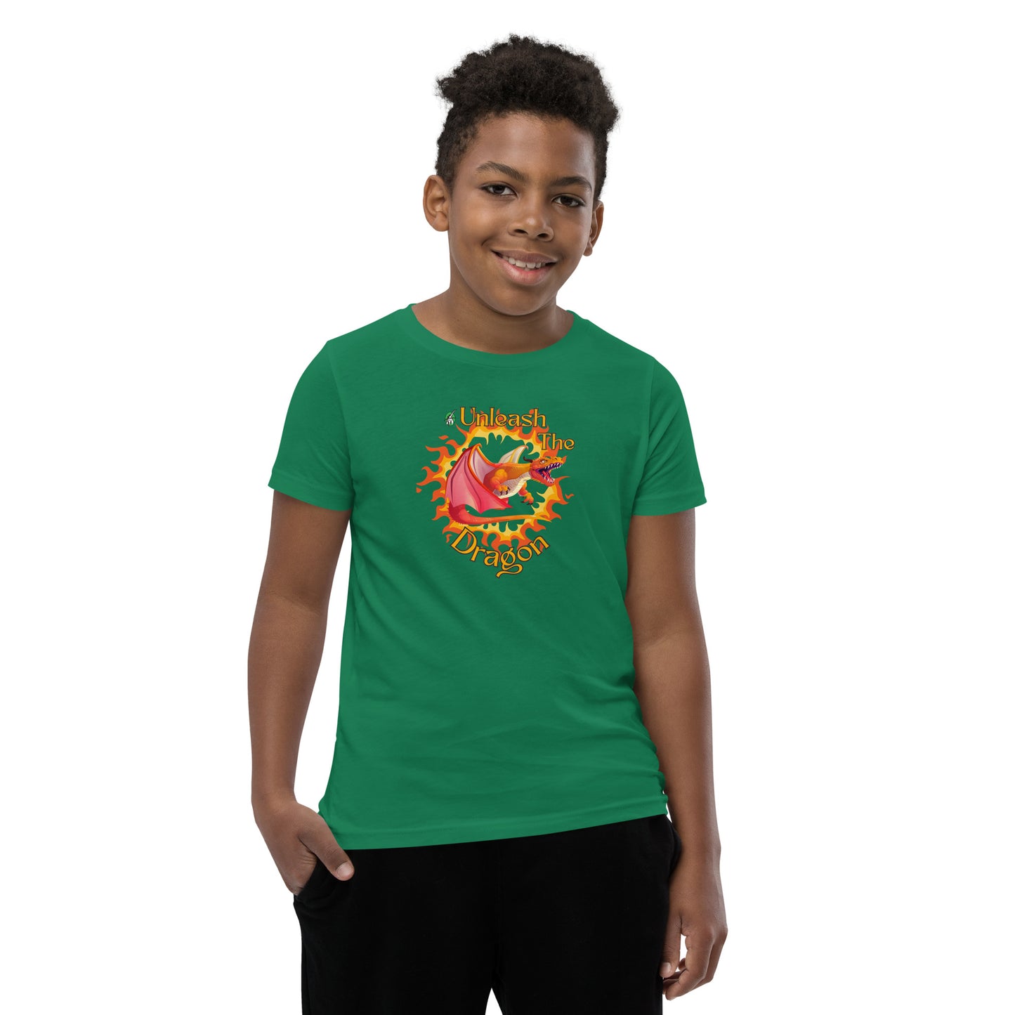  A boy standing wearing a green kids t-shirt with the printed graphic of a fire-breathing dragon with the statement, Unleash the Dragon. Designed by Wizard Prints