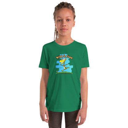 A girl standing wearing a green t-shirt with a funny graphic on the front of a giraffe running with the words, 'wild and free'  by Wizard Prints
