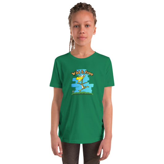 A girl standing wearing a green t-shirt with a funny graphic on the front of a giraffe running with the words, 'wild and free'  by Wizard Prints
