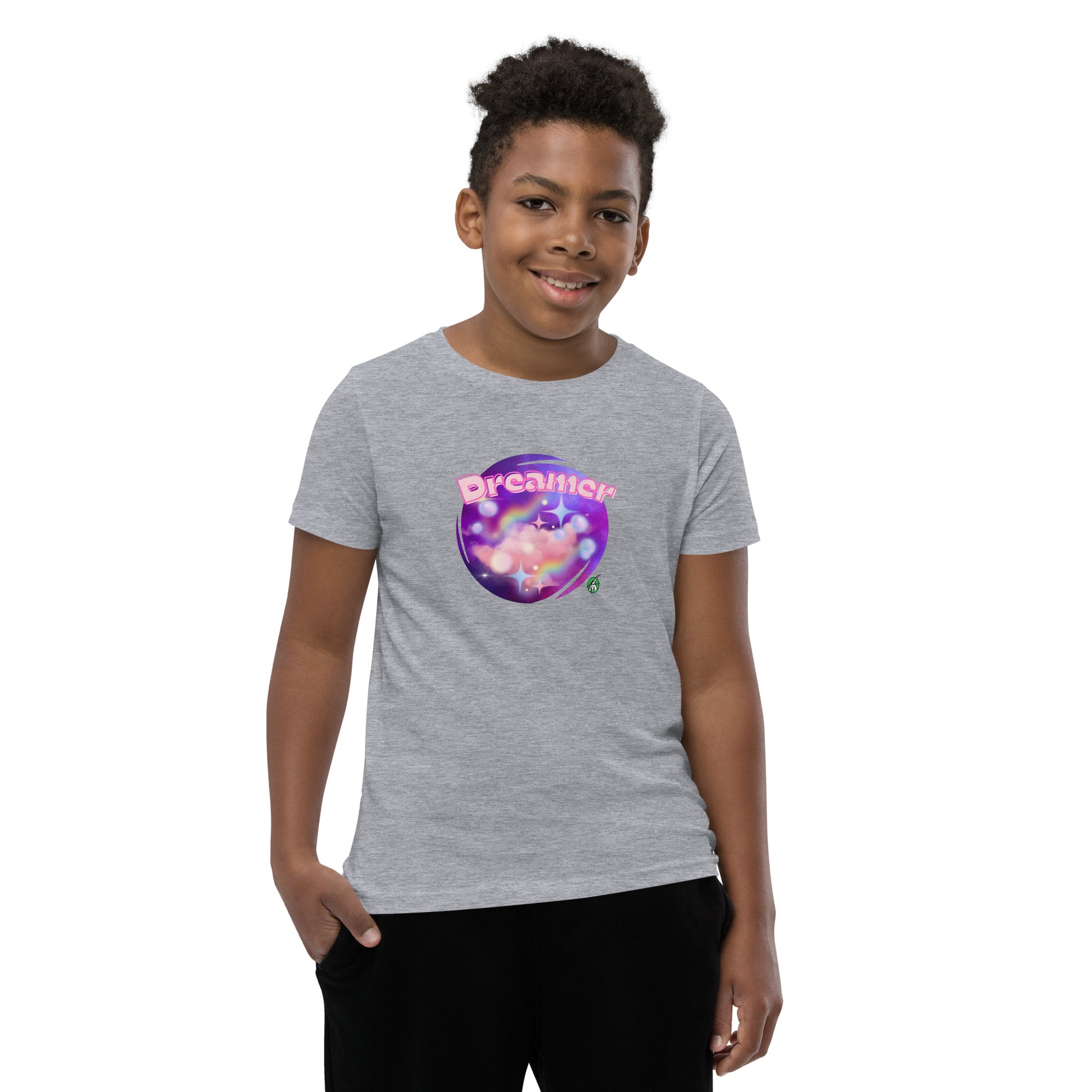  A boy standing wearing a grey kids t-shirt with the printed graphic of a galaxy and the word, Dreamer, by Wizard Prints