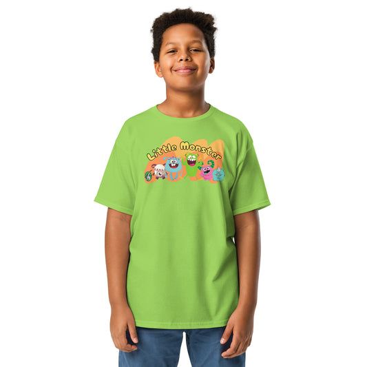 A boy standing wearing a lime green t-shirt with a printed graphic of colourful monsters with the words, 'Little Monster'. Designed by Wizard Prints.