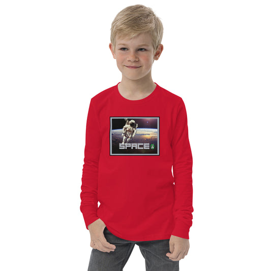 A boy standing and wearing a red long-sleeve T-shirt featuring a printed graphic of a real astronaut in space and the word "Space", by Wizard Prints.