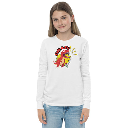 A girl standing and wearing a white long sleeve t-shirt with a printed graphic of a red roaring dinosaur and the word "Roar!", by Wizard Prints.