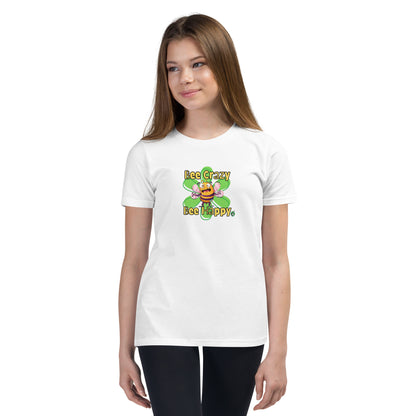  A girl standing wearing a white kids t-shirt with the printed graphic of a crazy bee and the statement, Bee Crazy Bee Happy. Designed by Wizard Prints