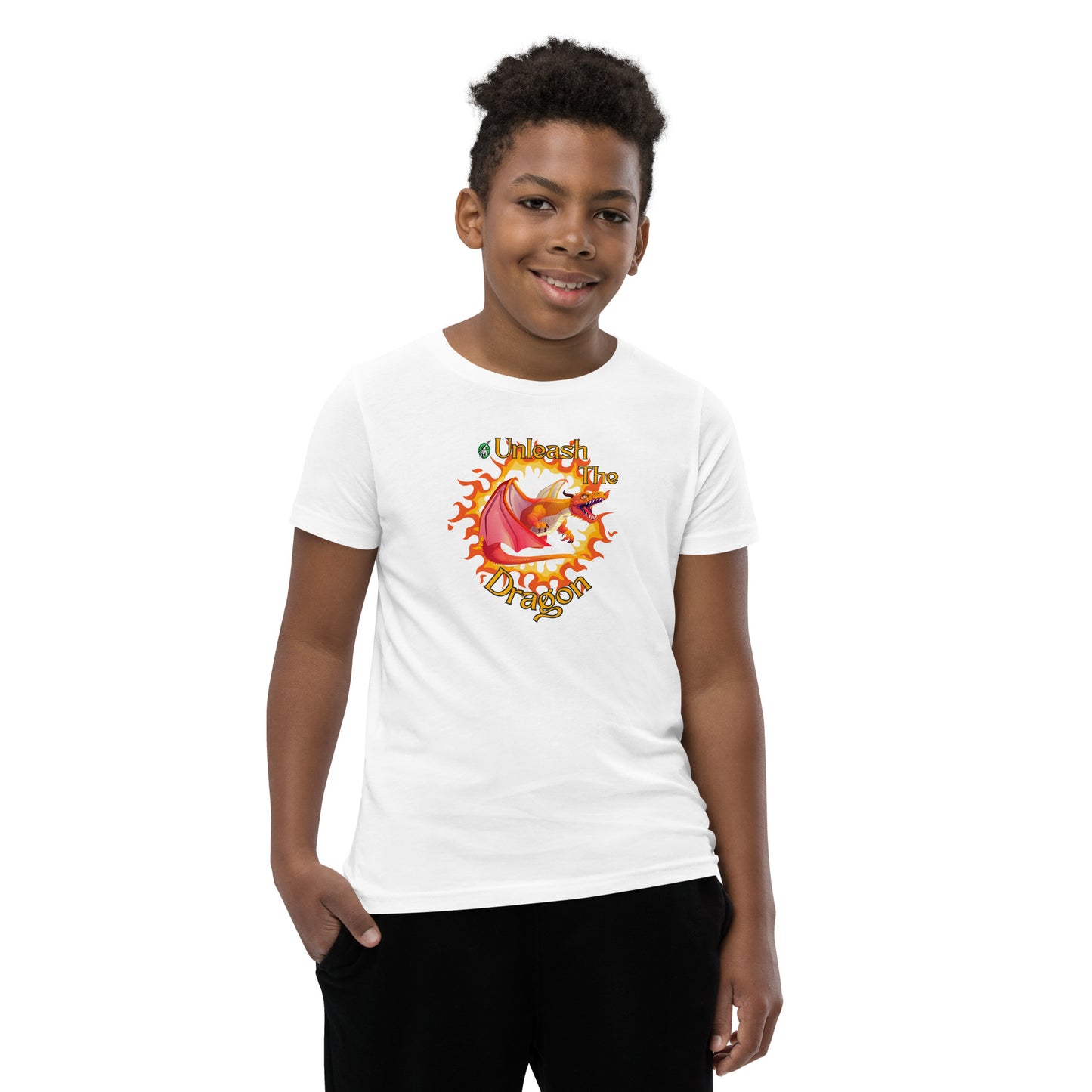  A boy standing wearing a white kids t-shirt with the printed graphic of a fire-breathing dragon with the statement, Unleash the Dragon. Designed by Wizard Prints