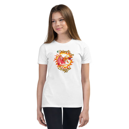  A girl standing wearing a white kids t-shirt with the printed graphic of a fire-breathing dragon with the statement, Unleash the Dragon. Designed by Wizard Prints