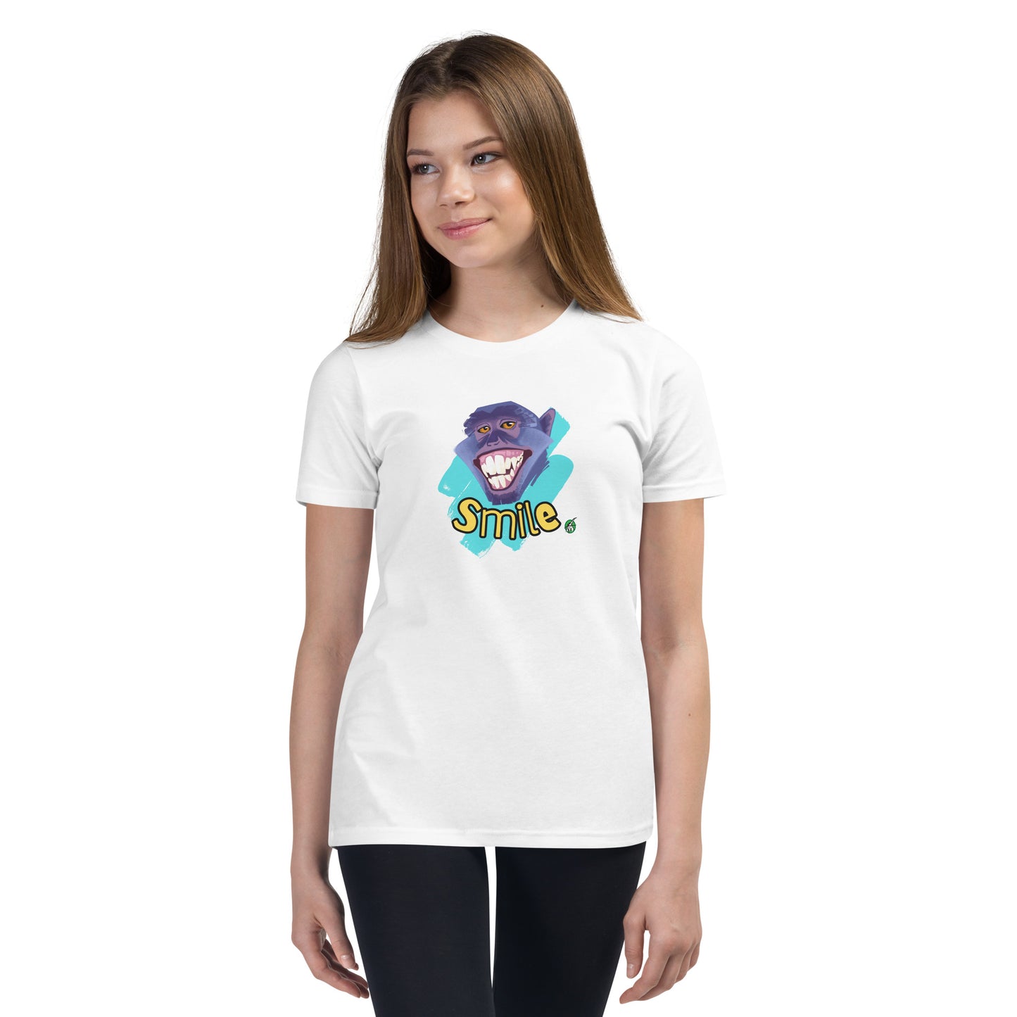  A girl standing wearing a white kids t-shirt with the printed graphic of a smiling monkey and the word, Smile. Designed by Wizard Prints