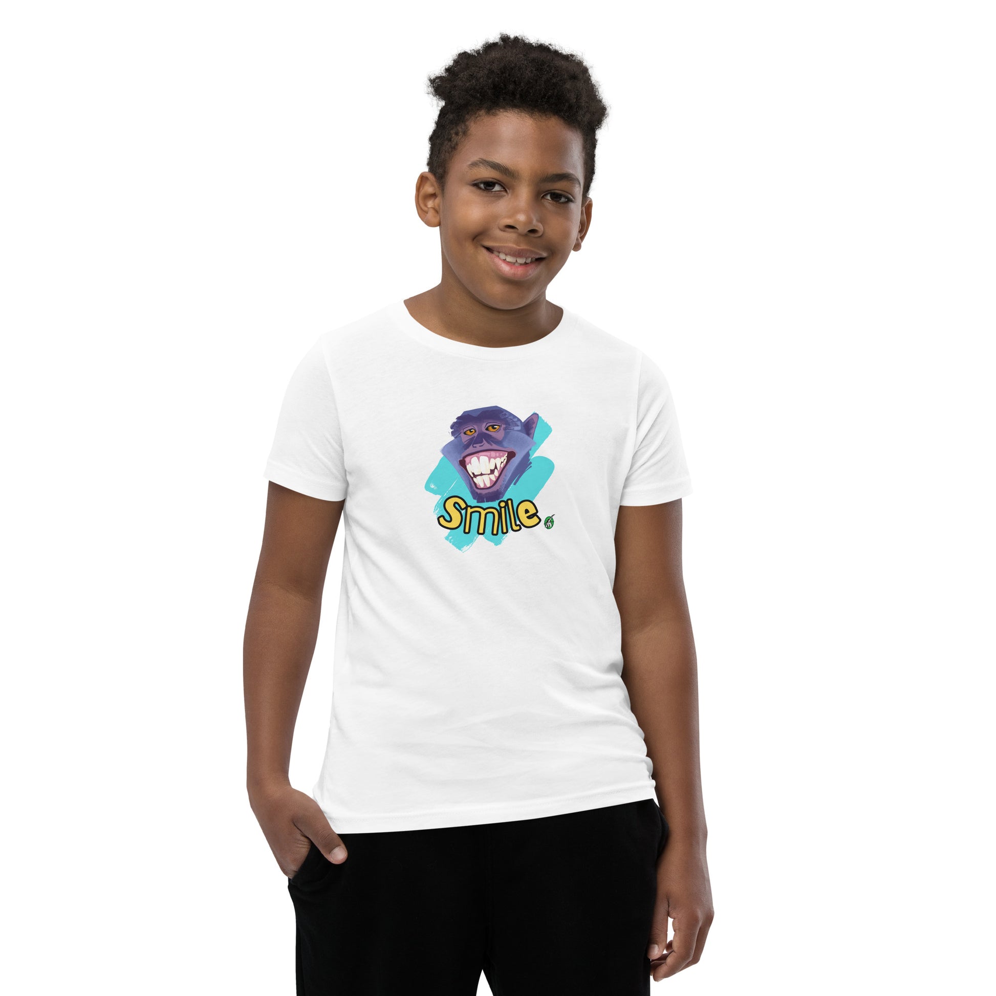  A boy standing wearing a white kids t-shirt with the printed graphic of a smiling monkey and the word, Smile. Designed by Wizard Prints