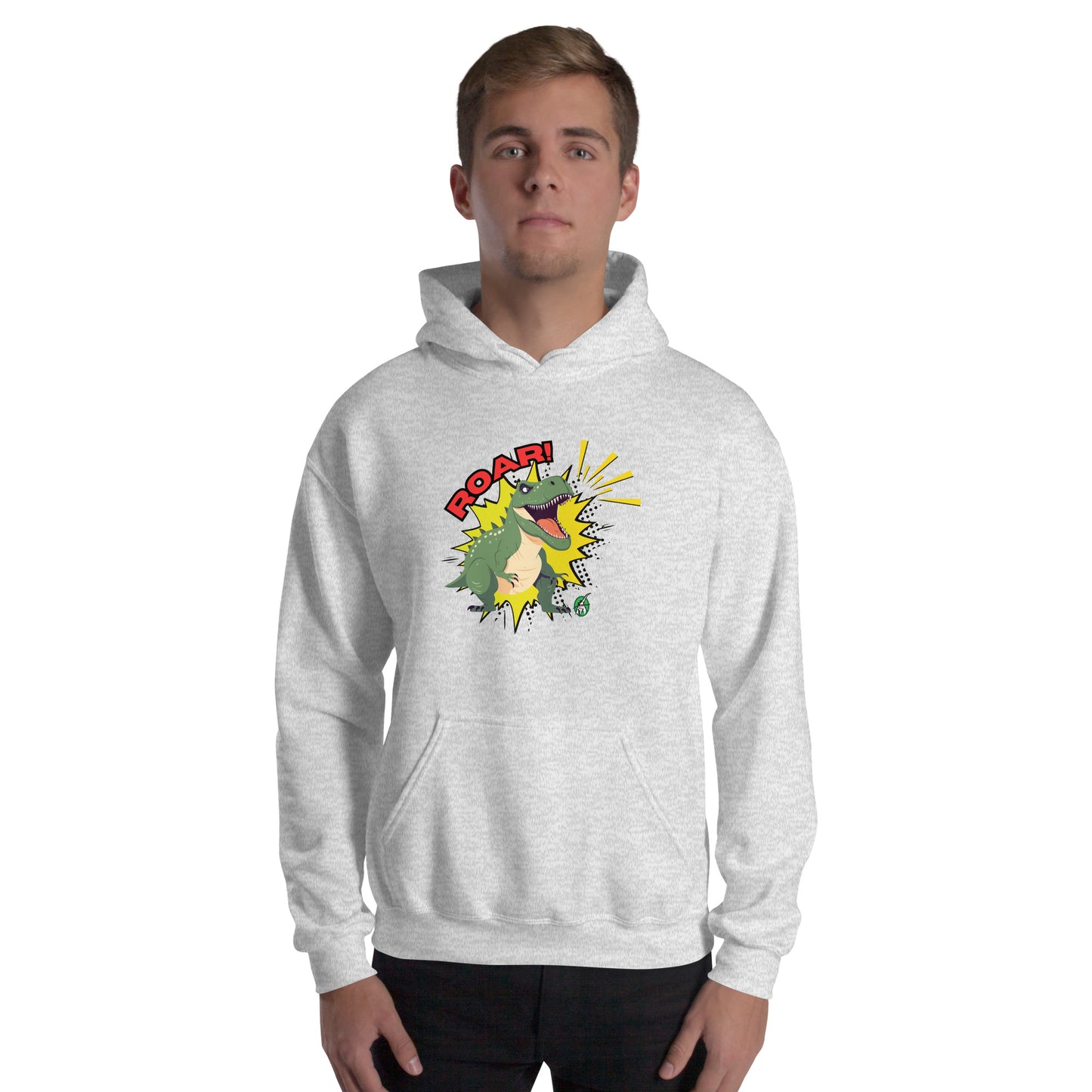 A man standing wearing an ash hoodie with a printed graphic of a green roaring cartoon dinosaur and the word Roar! Designed by Wizard Prints