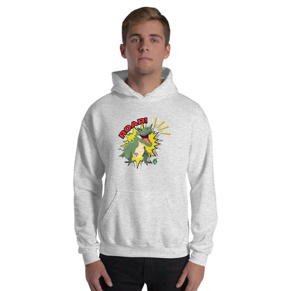 A man standing wearing an ash hoodie with a printed graphic of a green roaring cartoon dinosaur and the word Roar! Designed by Wizard Prints