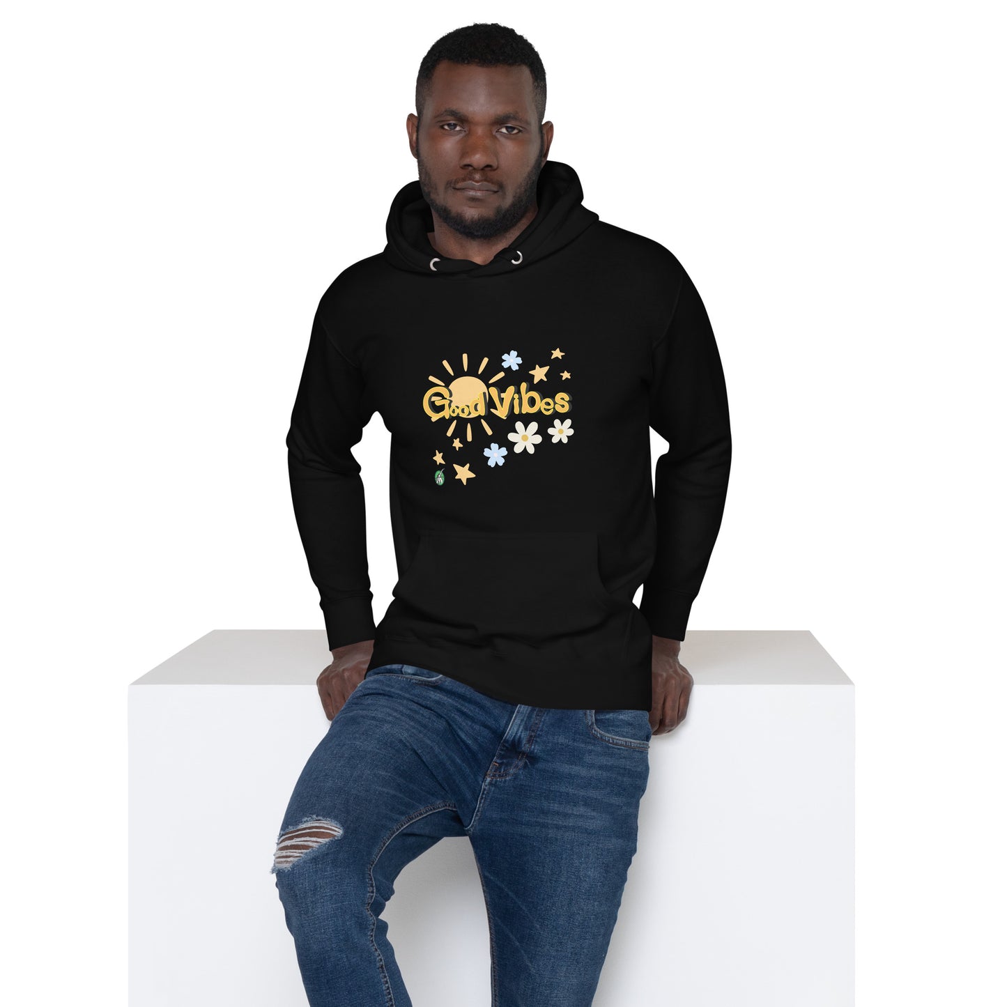 A man standing wearing a black hoodie with a printed graphic of the sun with the words, 'Good Vibes'. Designed by Wizard Prints