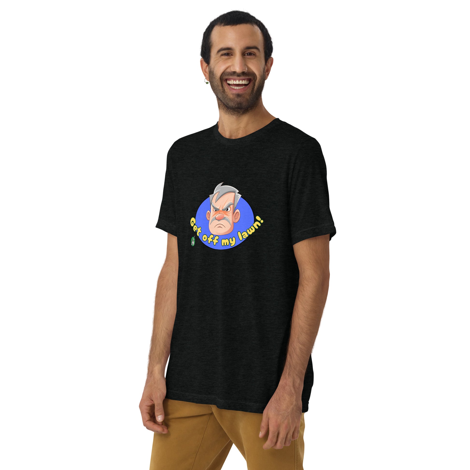 A man standing wearing a black tee shirt with a printed graphic of an old man's grumpy face with the words, Get Off My Lawn. Designed by Wizard Prints