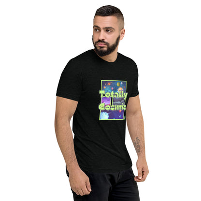 A man standing wearing a black t-shirt by Wizard Prints featuring a printed graphic of colorful planets in the background with the words “Totally Cosmic” on top.