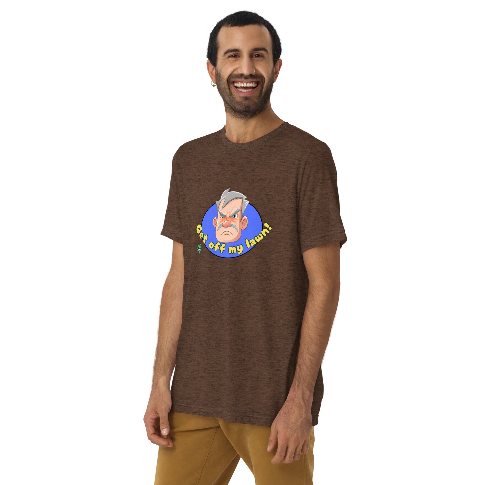 A man standing wearing a brown tee shirt with a printed graphic of an old man's grumpy face with the words, Get Off My Lawn. Designed by Wizard Prints