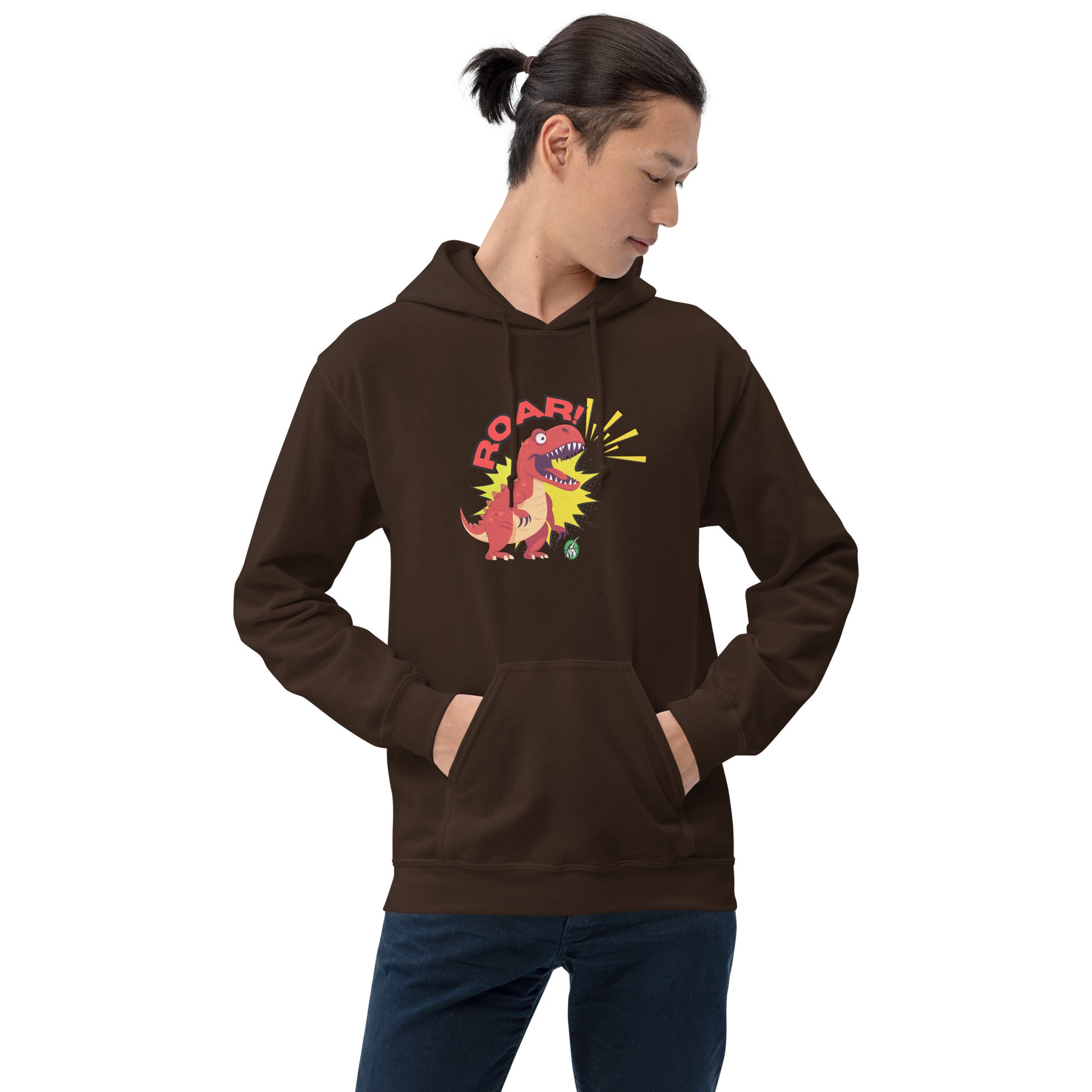 A man standing wearing a brown hoodie with a printed graphic of a red roaring cartoon dinosaur and the word Roar! Designed by Wizard Prints