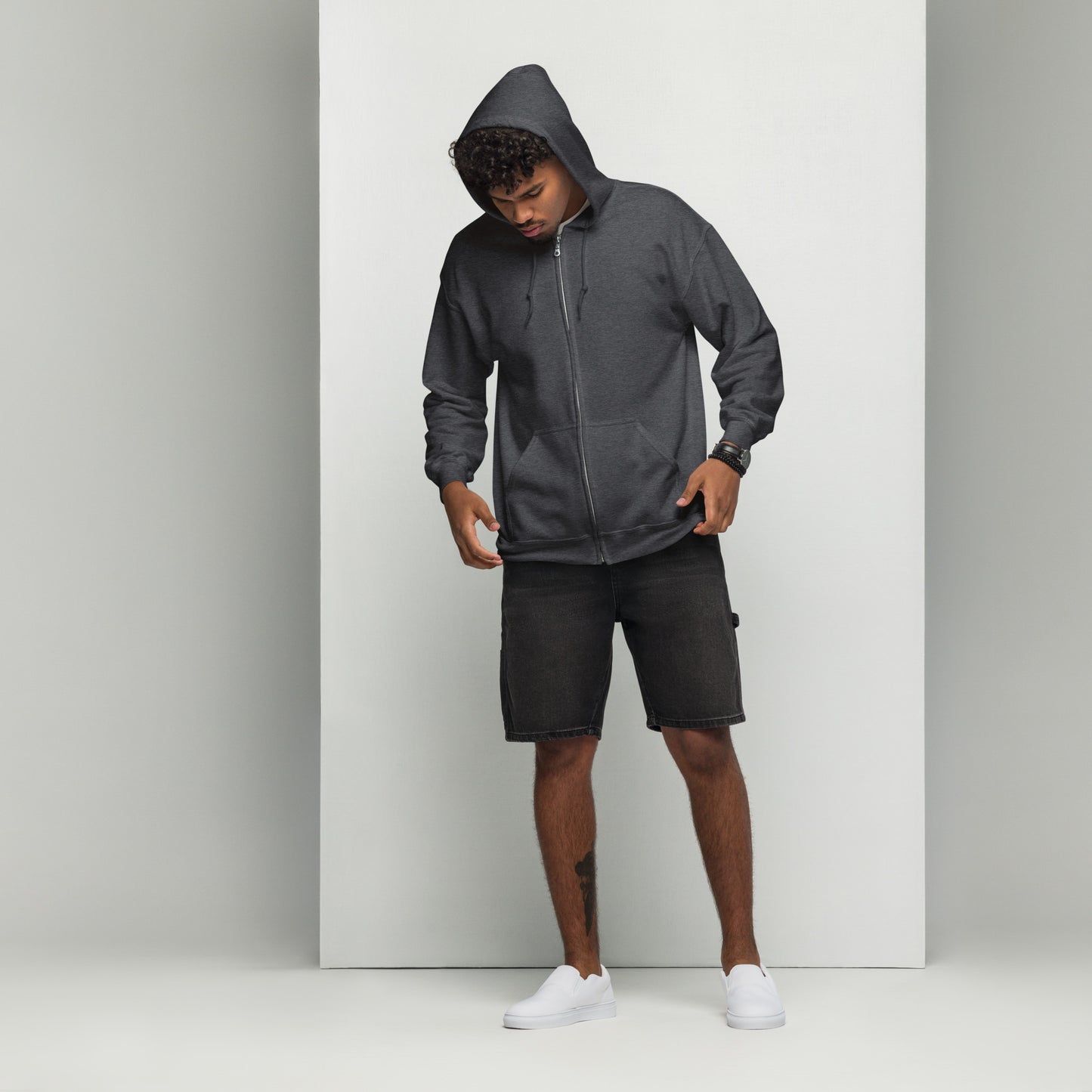 A man standing wearing a dark grey zip through hoodie by Wizard Prints Shop and shorts