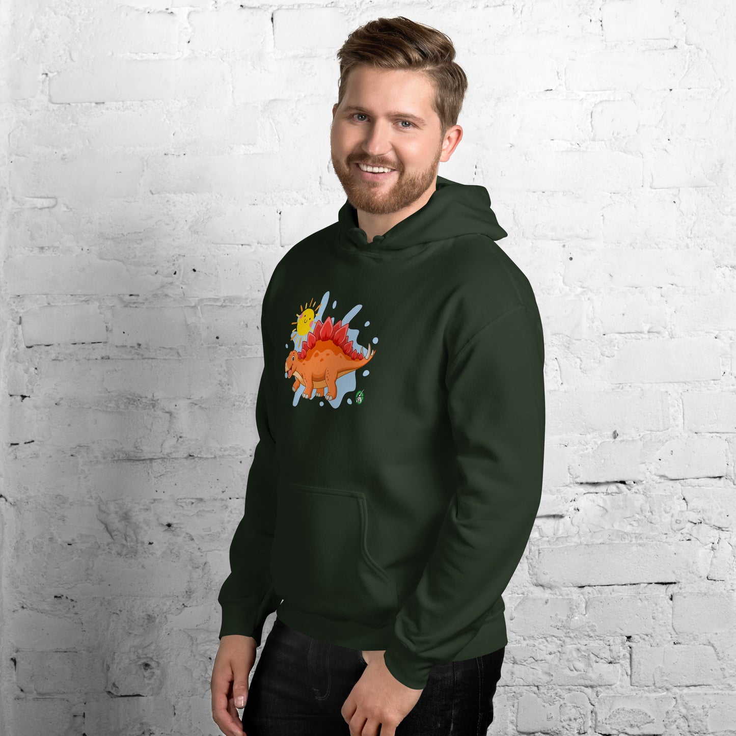A man standing wearing a forest green hoodie with the printed graphic of an orange cartoon dinosaur and the sun, by Wizard Prints.