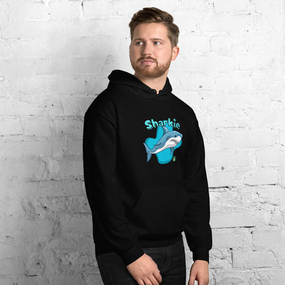 A man standing wearing a black hoodie with a printed graphic of a cartoon shark and the word, Sharkie. Designed by Wizard Prints.