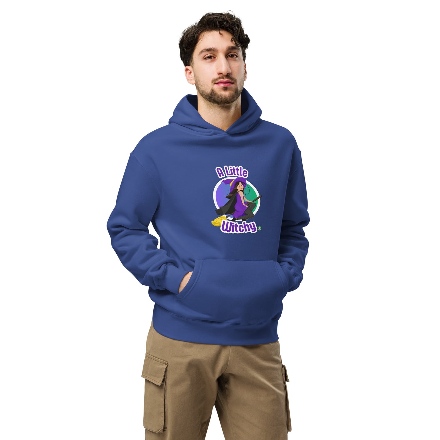 A man standing wearing a blue hoodie by Wizard Prints featuring a printed graphic of a witch riding a flying broom, with the text, A Little Witchy.