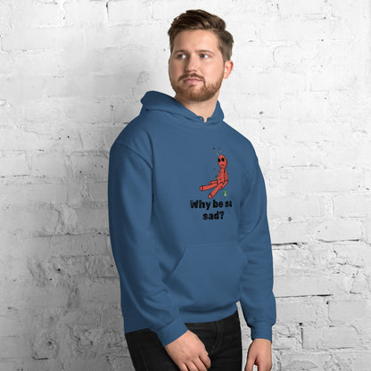 A man standing wearing an indigo hoodie with a printed graphic of a voodoo doll and the words, Why be so sad? Designed by Wizard Prints.