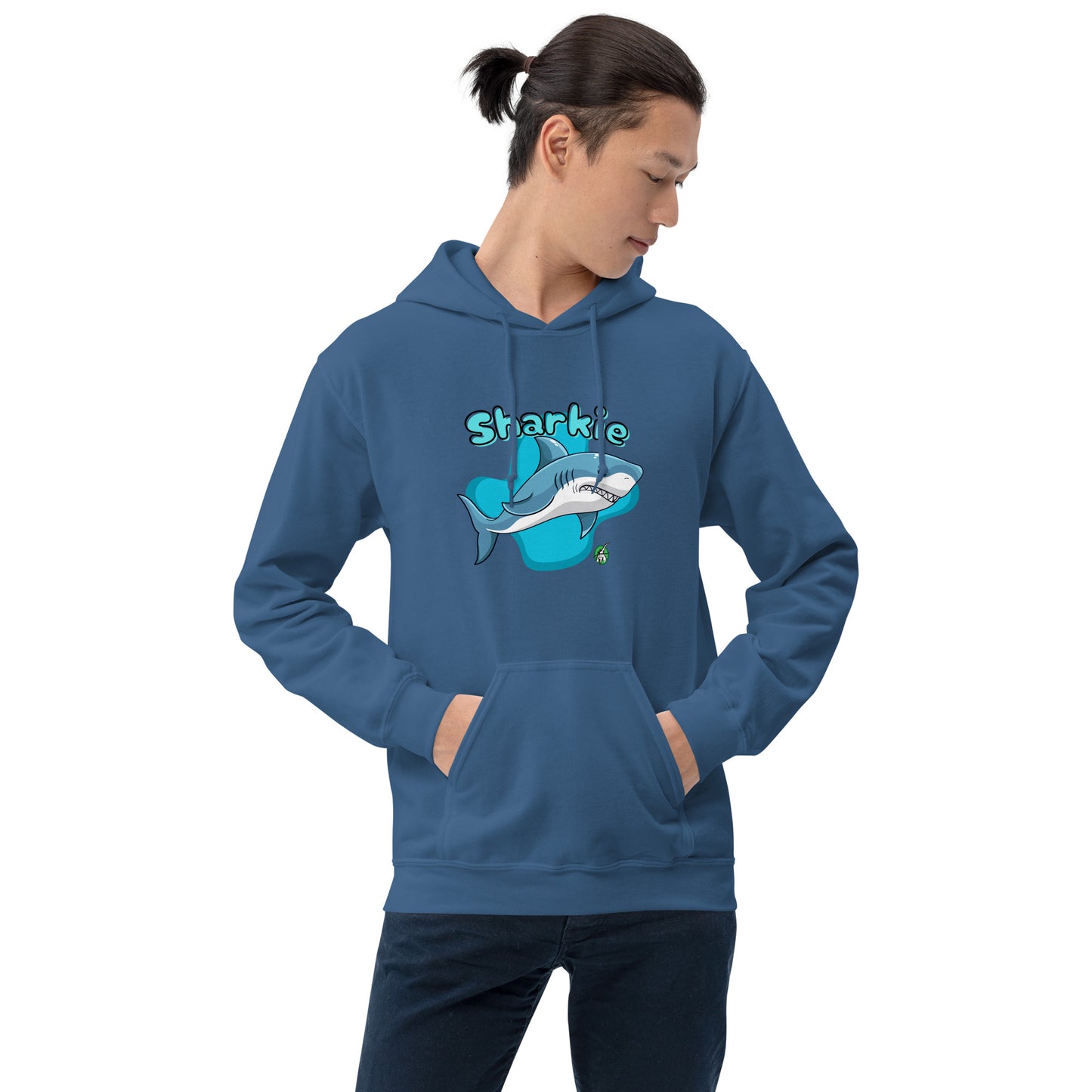 A man standing wearing an indigo hoodie with a printed graphic of a cartoon shark and the word, Sharkie. Designed by Wizard Prints.