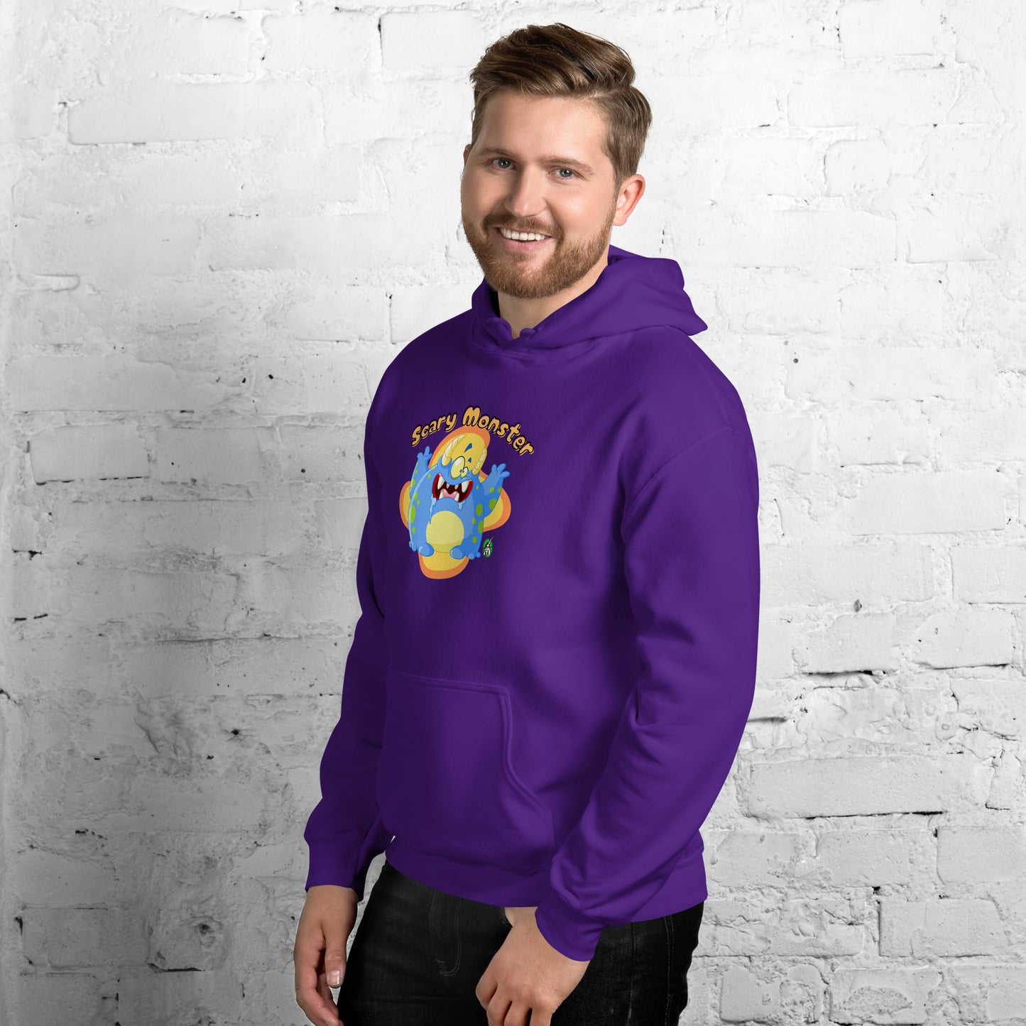 A man standing wearing a purple hoodie with a printed graphic of a cartoon monster and the words, Scary Monster. Designed by Wizard Prints.