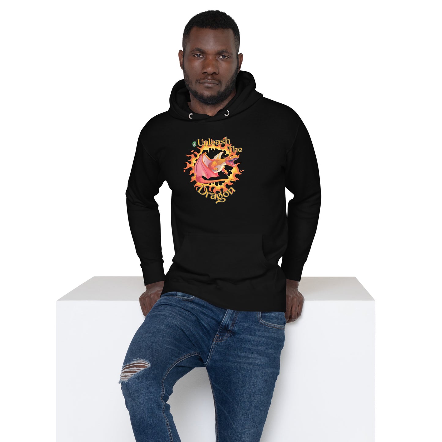 A man standing and wearing a black hoodie with a printed graphic of a fire-breathing dragon with the words, 'Unleash the Dragon'. Designed by Wizard Prints