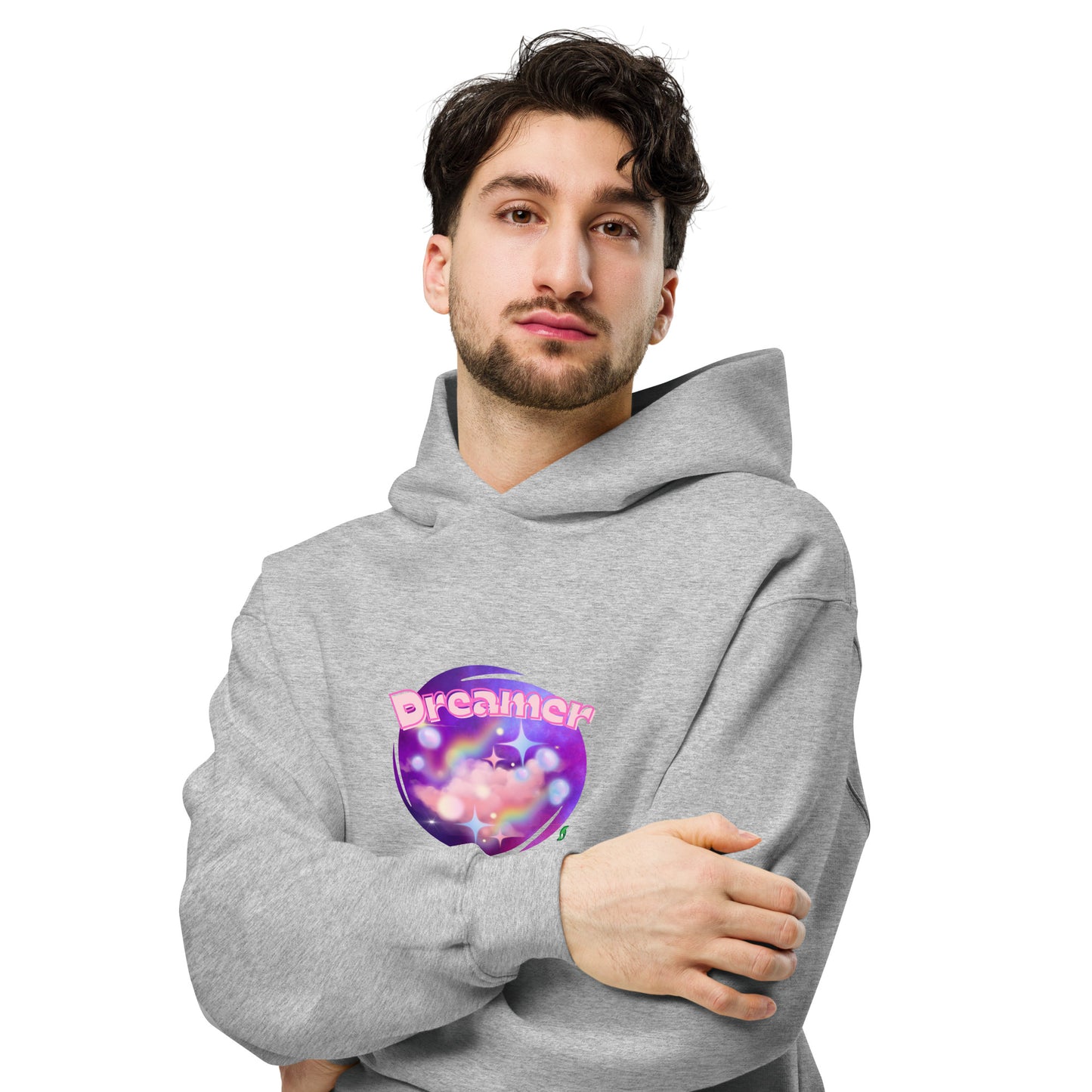 A man standing wearing a grey hoodie by Wizard Prints featuring a printed graphic of a galaxy background and the word Dreamer on top.