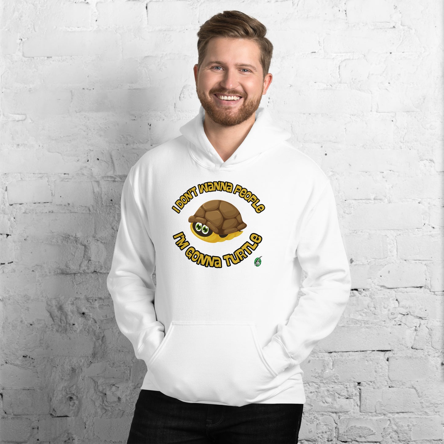 A man standing wearing a white hoodie with a printed graphic of a turtle with the words, 'I Don't Wanna People, I'm Gonna Turtle'. Designed by Wizard Prints.