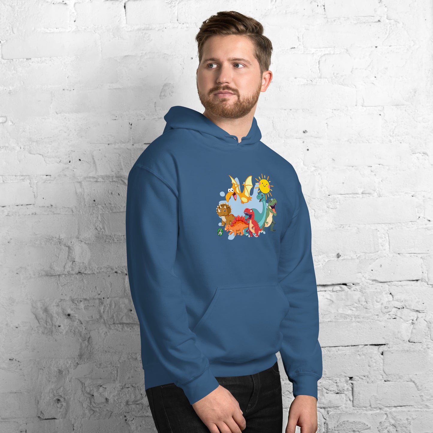 A man standing wearing an indigo hoodie with a printed graphic of different colorful dinosaur types and the sun. Designed by Wizard Prints.