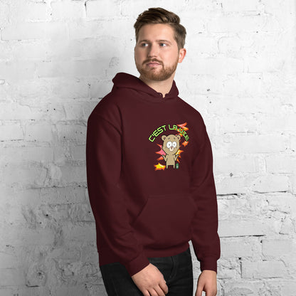 A man standing wearing a maroon hoodie by Wizard Prints featuring a printed graphic of a shrugging cartoon bear and the words, C'est La Vie.
