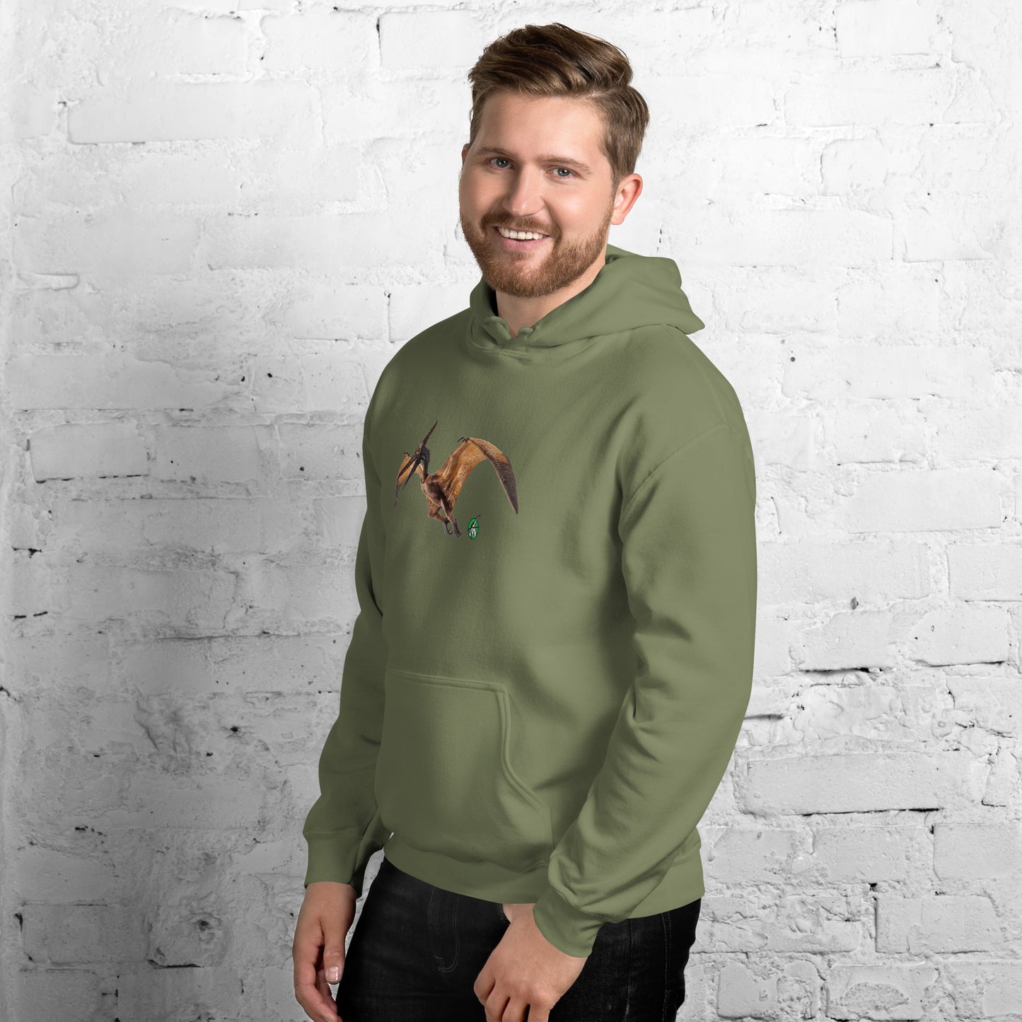A man standing wearing a military green hoodie with a printed graphic of a life like dinosaur. Designed by Wizard Prints.