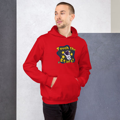 A man standing wearing a red hoodie with a printed graphic of a cartoon astronaut and the words, Touch the Stars. Designed by Wizard Prints.