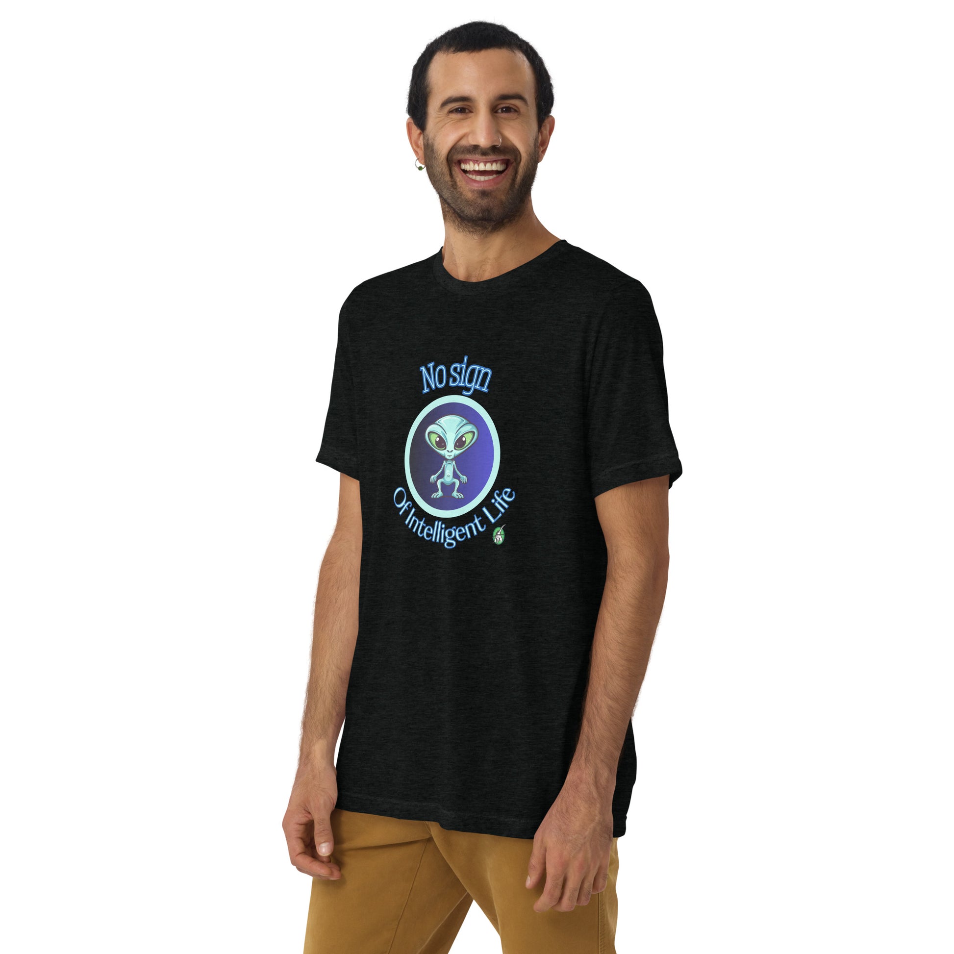 A man standing wearing a black tee shirt with a printed graphic of a blue alien and the words No Sign of Intelligent Life. Designed by Wizard Prints