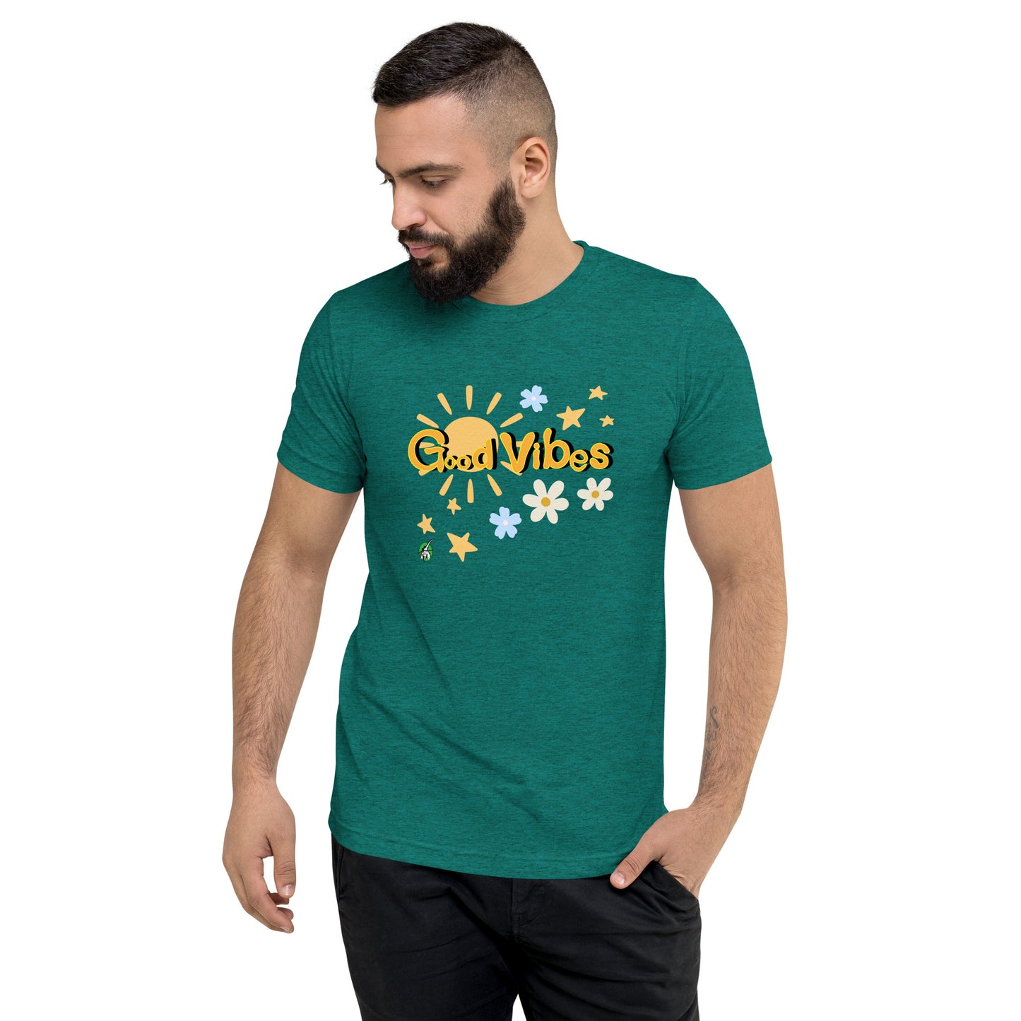 A man standing wearing a blue green tee shirt with a printed graphic of the sun and the words, Good Vibes. Designed by Wizard Prints