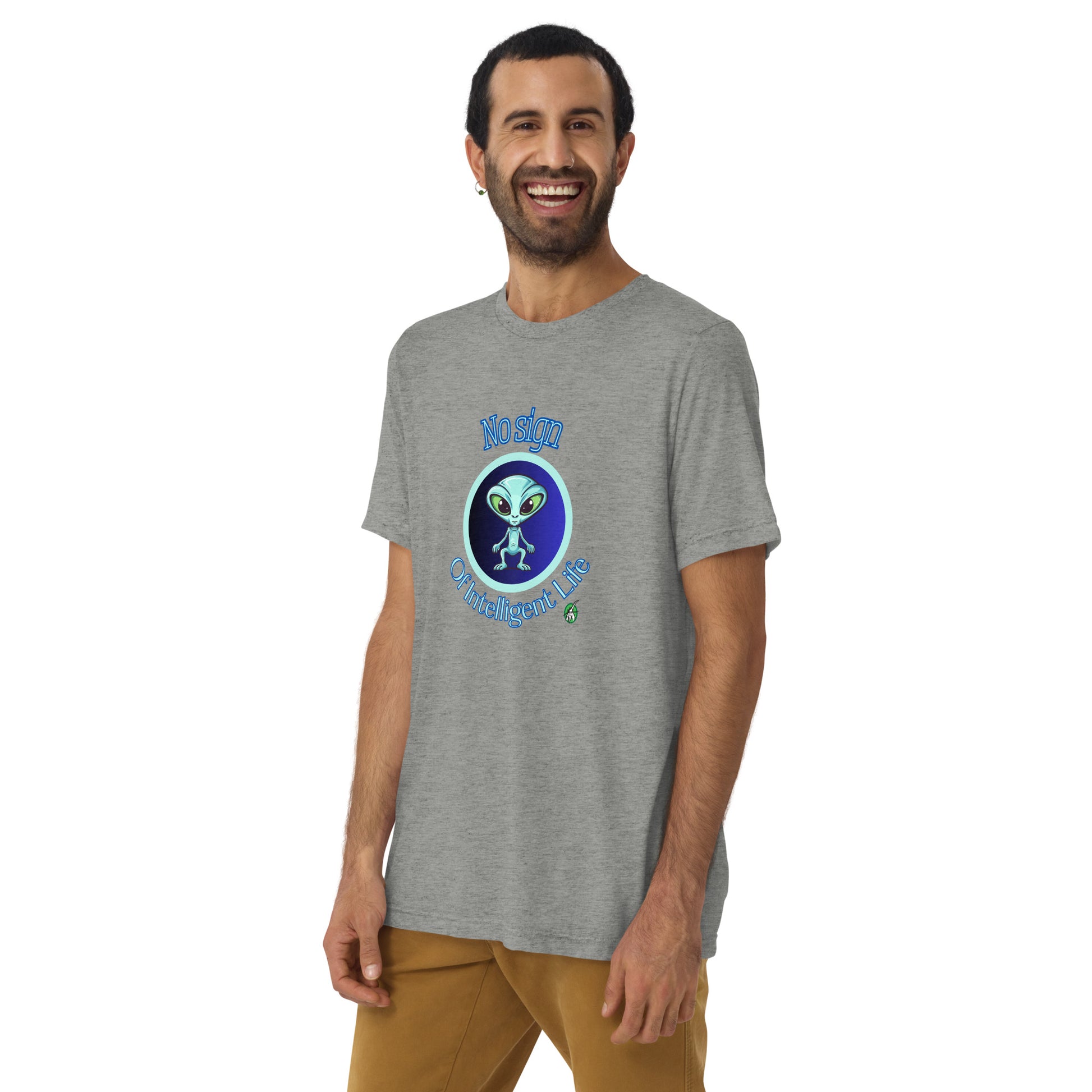 A man standing wearing a grey tee shirt with a printed graphic of a blue alien and the words No Sign of Intelligent Life. Designed by Wizard Prints