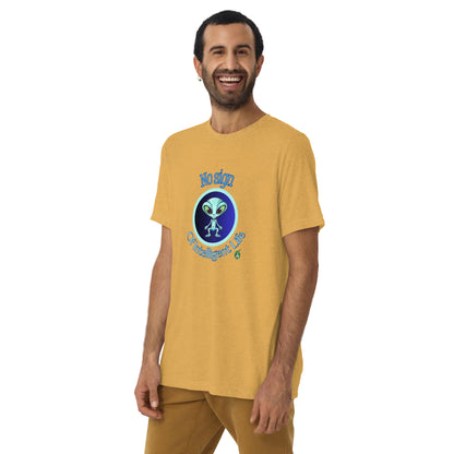 A man standing wearing a mustard tee shirt with a printed graphic of a blue alien and the words No Sign of Intelligent Life. Designed by Wizard Prints