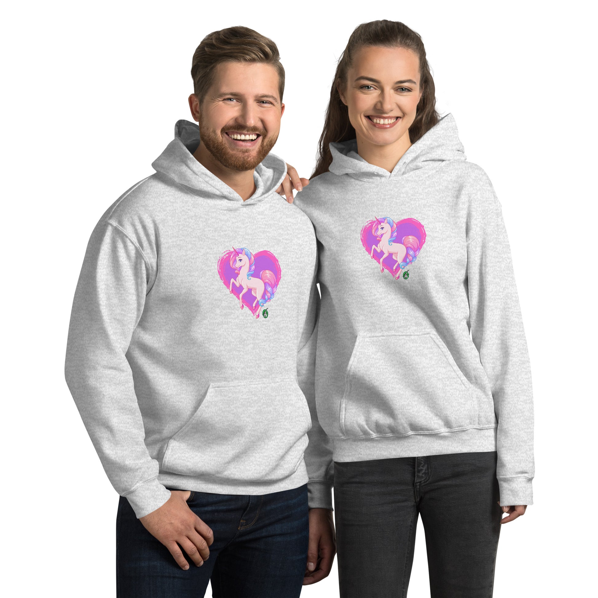 A man and a woman standing wearing an ash hoodie featuring a graphic of a pink unicorn on a purple heart background, designed by Wizard Prints.