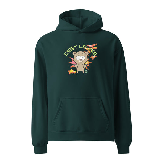 A unisex pine green hoodie by Wizard Prints featuring a printed graphic of a shrugging cartoon bear and the words, C'est La Vie.
