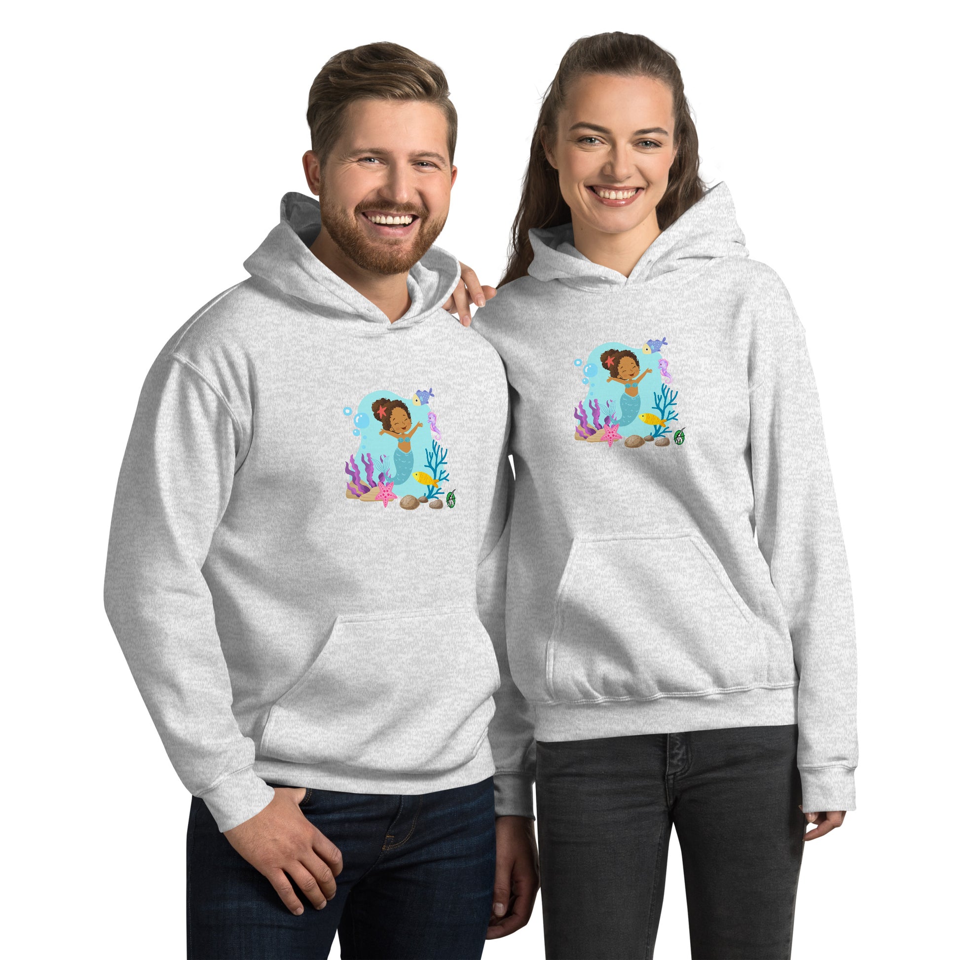A man and a woman standing wearing a grey hoodie featuring a  curly mermaid design surrounded by sea creatures and water. Designed  Wizard Prints creation.