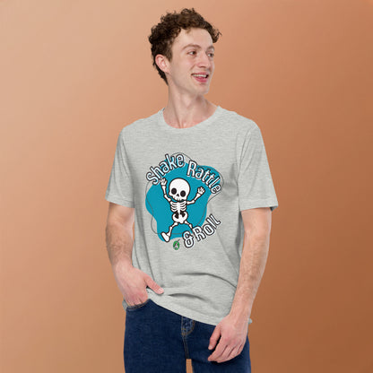 A man standing wearing a Wizard Prints Halloween tee shirt in army green with a printed graphic on front of a skeleton dancing saying shake rattle and roll!