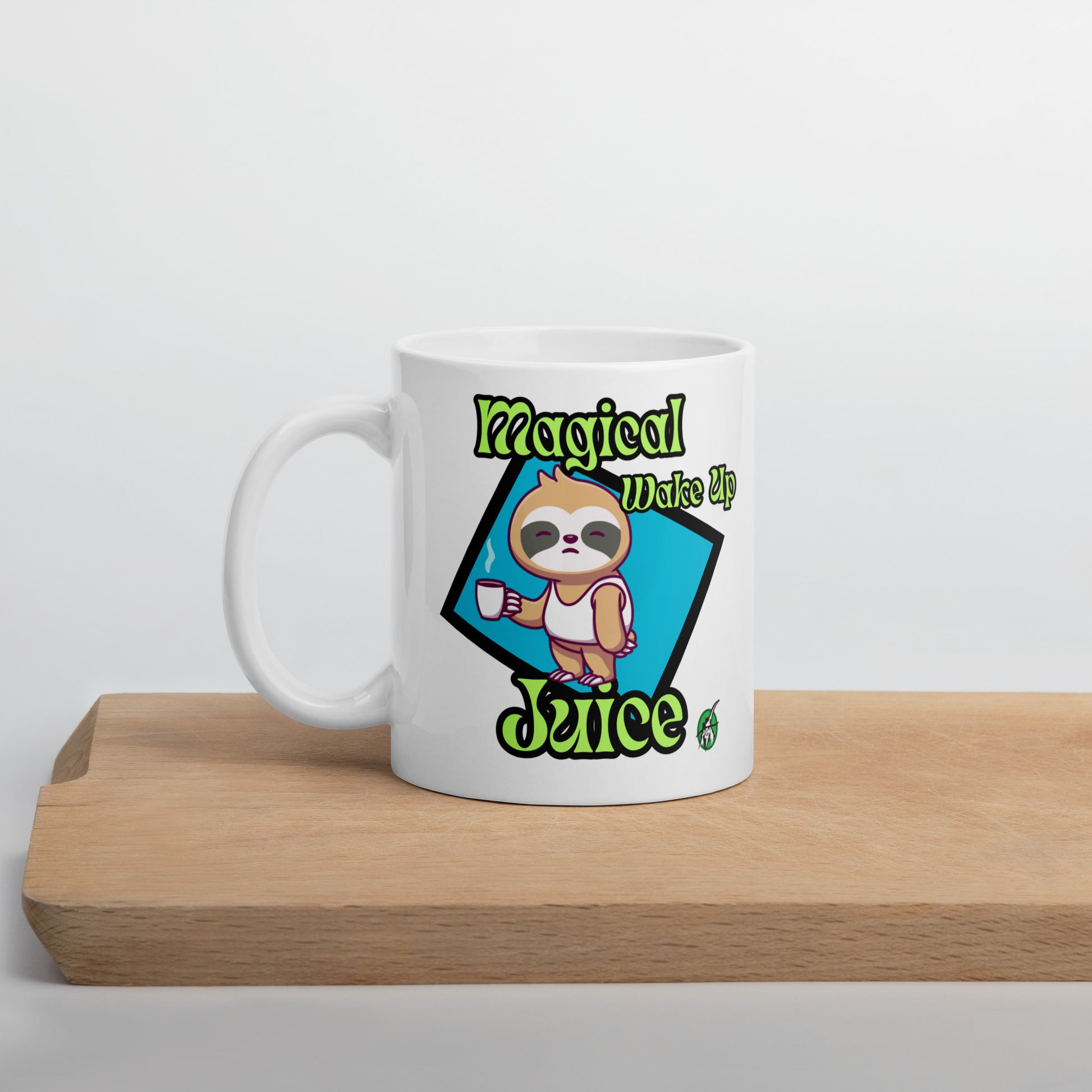 White Wizard Prints mug with a cartoon sloth design and 'Magical Wake up Juice' text on a wooden surface.