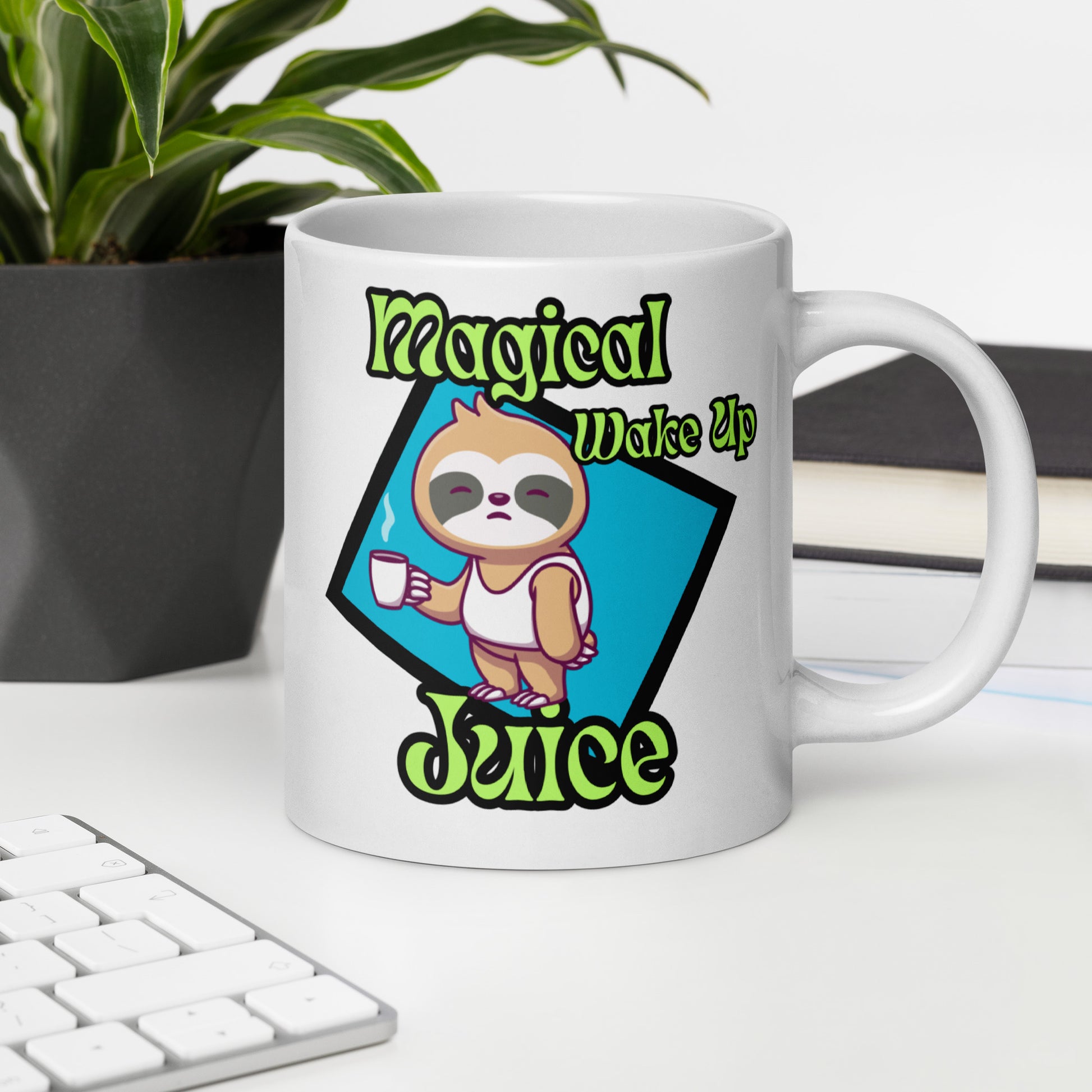 White Wizard Prints mug with a cartoon sloth design and 'Magical Wake up Juice' text on a desk with a keyboard and plant.