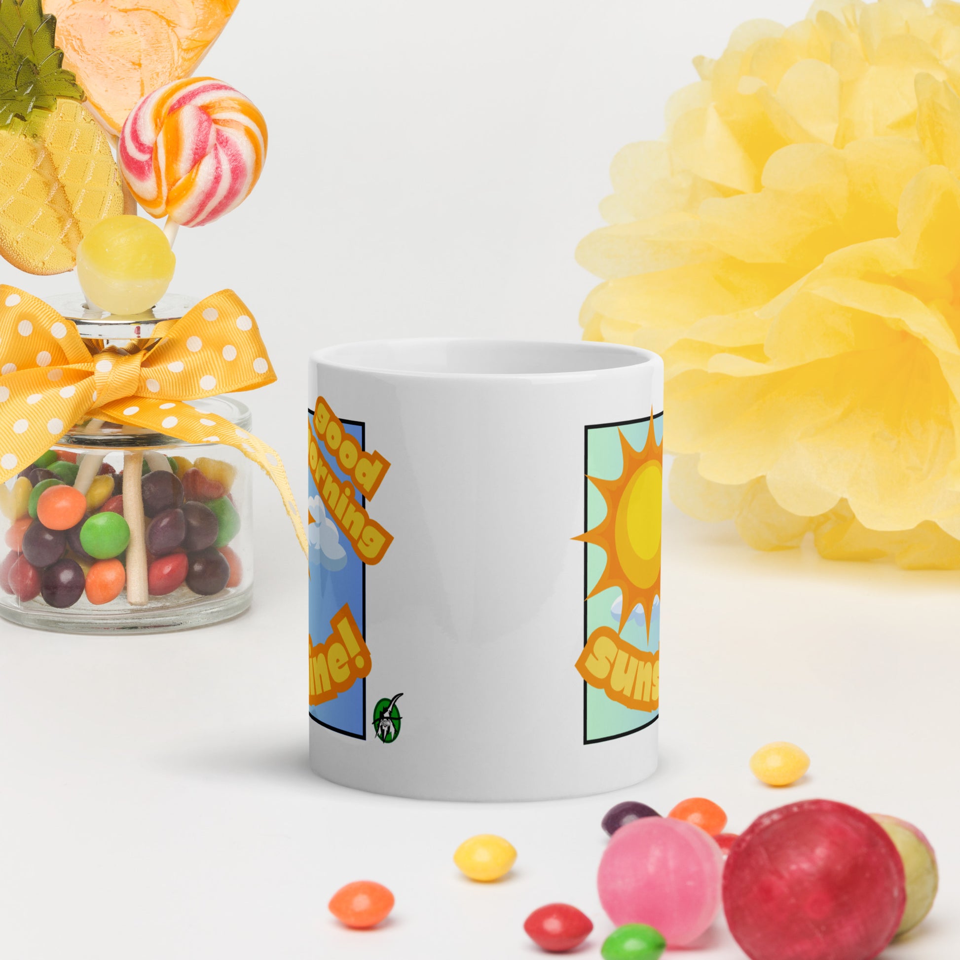 White Wizard Prints mug with 'Good morning sunshine' text and sunny graphic surrounded by candy and flowers on a white background.