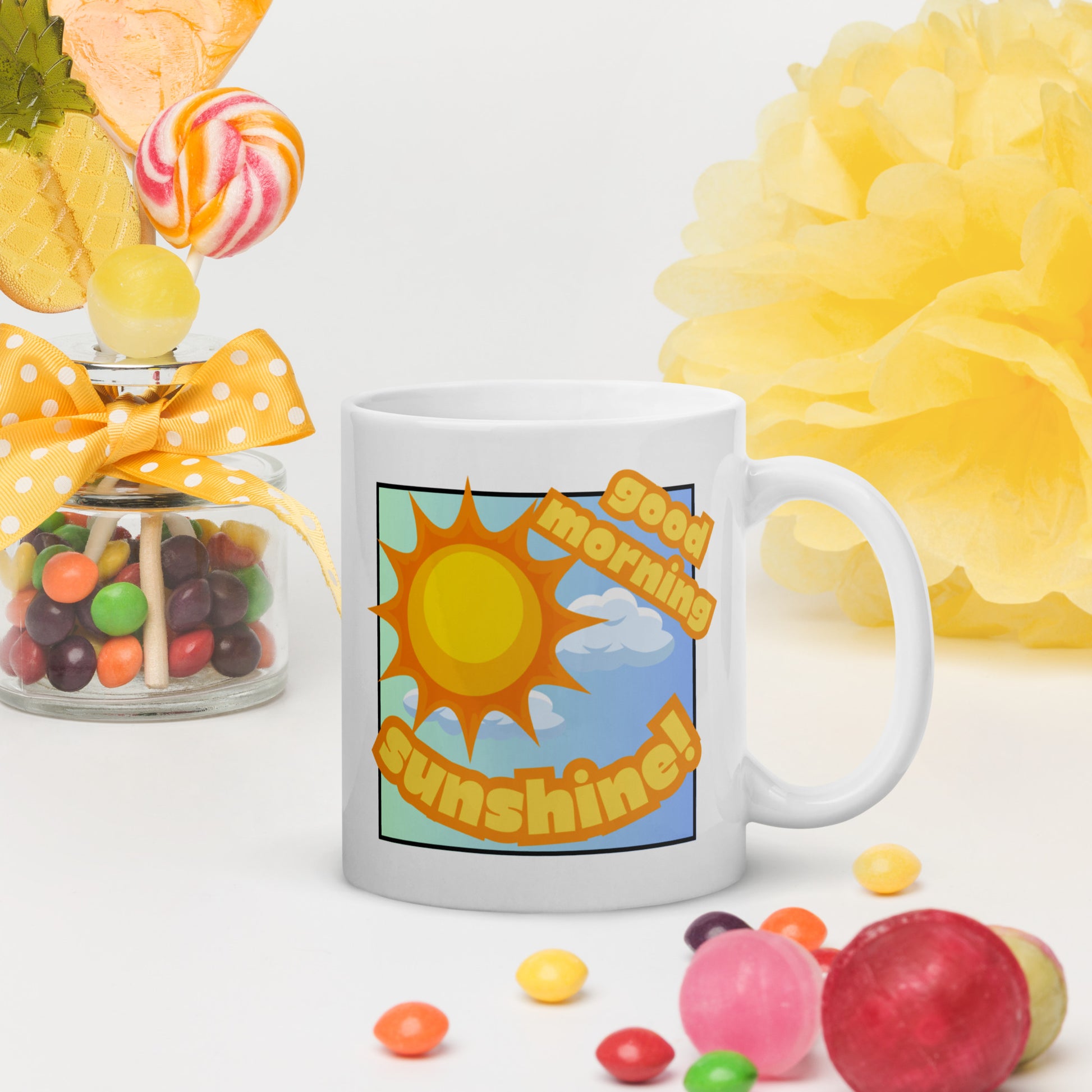 White Wizard Prints mug with 'Good morning sunshine' text and sunny graphic surrounded by colourful candies and flowers on a white background.