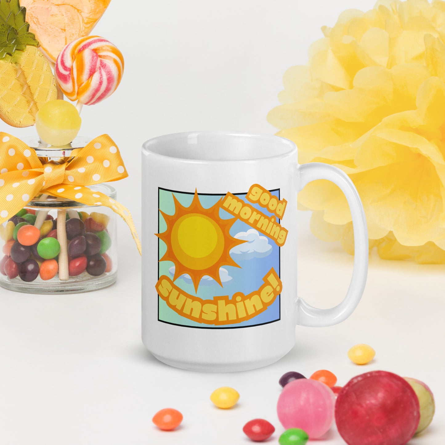 White Wizard Prints mug with 'Good morning sunshine' text and sunny graphic surrounded by candy and flowers on a white background.
